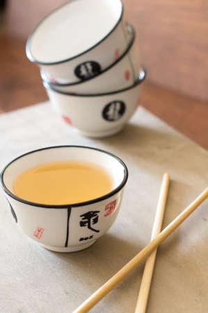 Green tea in a chinese tea set with cups and pot