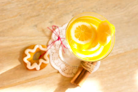 Glass with cut lemon fruit and water