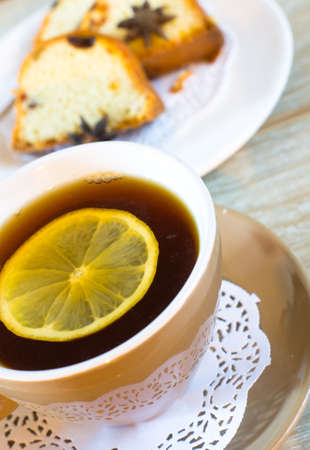 Sweets with anise spice with lemon tea on the wooden tableの写真素材