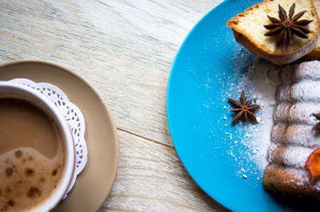Cup of coffee with cakes in blue plateの写真素材