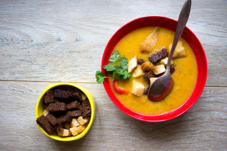 Vegetable soup with bread on the wooden tableの写真素材