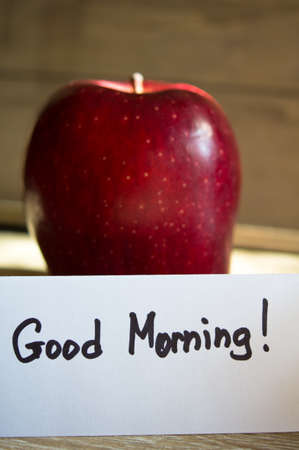 Apple and Good morning note on the wooden tableの写真素材