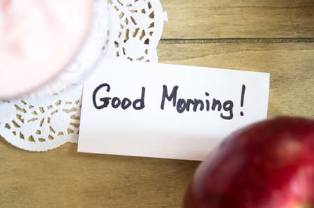 Glass of yoghurt and apple on the tableの写真素材