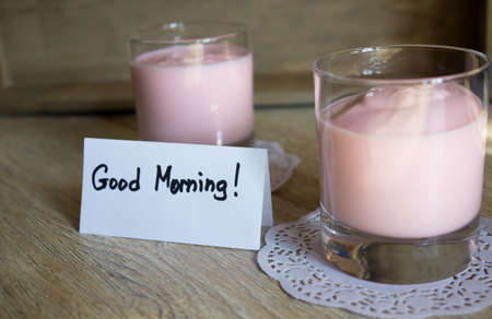 Glass of yoghurt and apple on the tableの写真素材