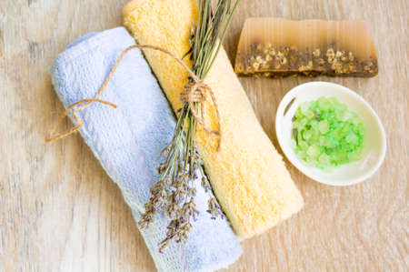 Bunch of lavender, soap and sea salt on a wooden tableの写真素材
