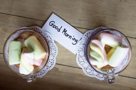 Cocoa drink and sweet paste zephyr in the glass on the wooden tableの写真素材