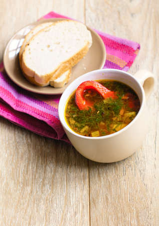 Dinner time, vegetable soup with pepper on the table