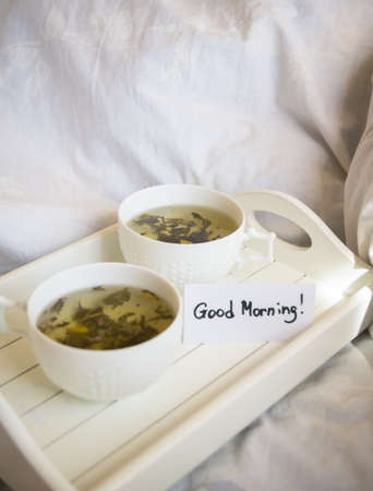 Morning tea, cup with green tea on the tableの写真素材
