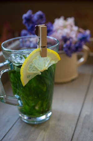 Estragon lemonade and first spring flowers on the table,の写真素材