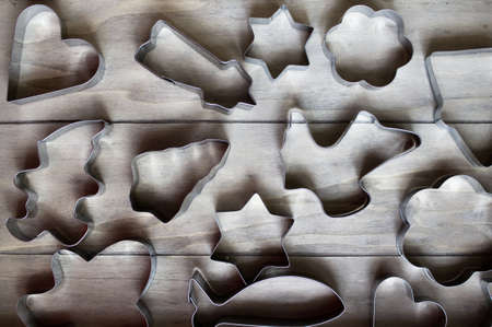 Detail of various cookies cutters on the wooden tableの写真素材