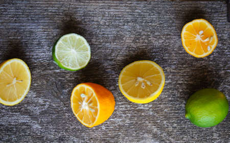 Lime and lemon different sorts on the wooden background, selective focusの写真素材