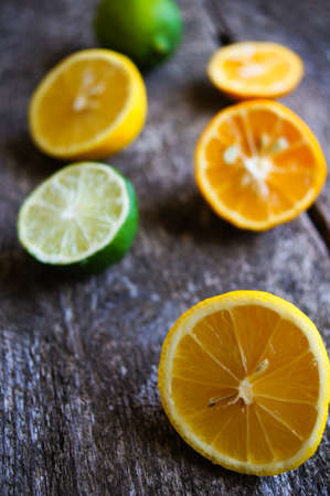 Lime and lemon different sorts on the wooden background, selective focus