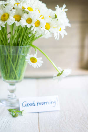 Summer time, wild daisy in the vase on the old wooden tableの写真素材
