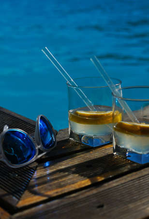 Gin and tonic cocktail on poolside barの写真素材