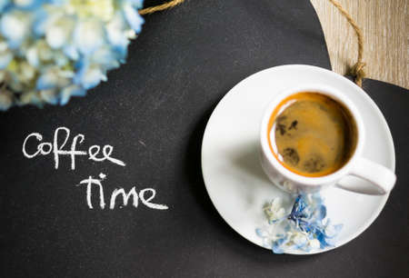 Hydrangea flowers in a vase, cup of coffee and noteの写真素材