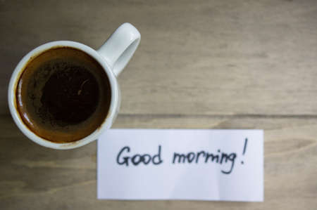 Good morning note and coffee in a cupの写真素材