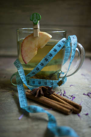Coreopsis flowers in a vase and cup of green tea in the morningの写真素材