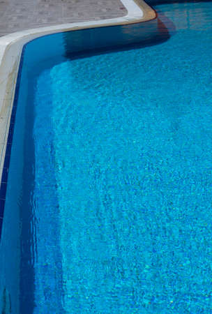 Outdoor pool in the tropical area with blue water and laderの写真素材