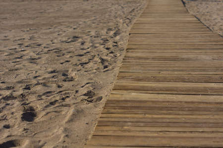 Wooden footbridge in the sand of a beach for access to the seaの写真素材