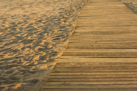 Wooden footbridge in the sand of a beach for access to the seaの写真素材