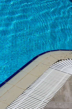 Outdoor pool in the tropical area with blue water and laderの写真素材