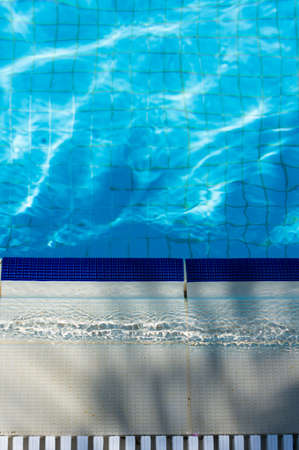 Outdoor pool in the tropical area with blue water and laderの写真素材