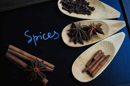 Spices like anice and cinnamon in the spoon and the chalkboardの写真素材