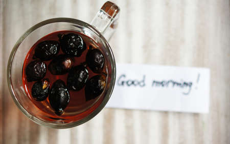 Rose hip tea with spices, cinnamon and anise star on the tableの写真素材