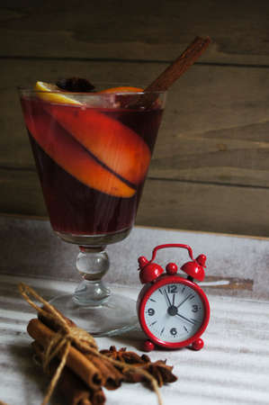 Mulled wine with spices on wooden backgroundの写真素材