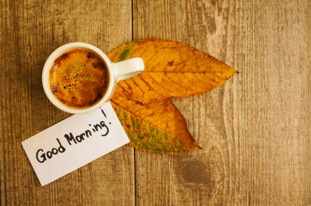 Autumn time, cup of coffee, yellow autumnal leaves and notes