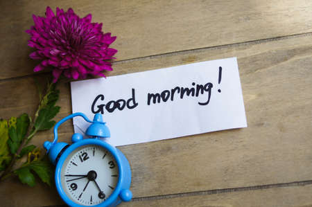 Good morning note and old-styled clock on the wooden backgroundの写真素材