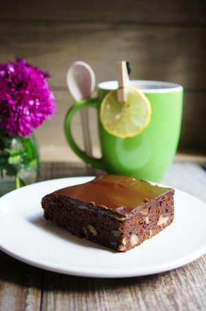 Cup of tea and piece of brownie cake for a breakfastの写真素材