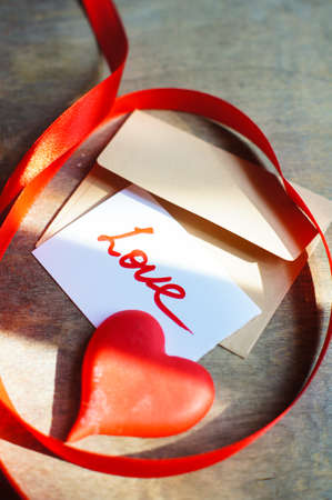 Letter with love note, red rose and sweers with heartsの写真素材
