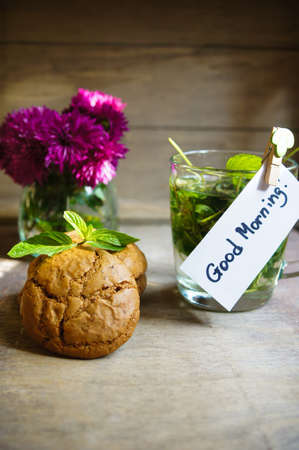 Mint tea and cookines with Good morning note on the wooden backgroundの写真素材