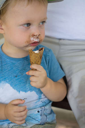 Little boy is eatting ice creamの写真素材