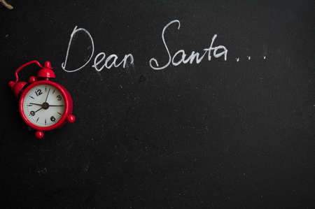 Dear Santa is written on a blackboard and christmas decorationの写真素材