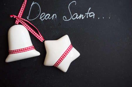 Dear Santa is written on a blackboard and christmas decorationの写真素材
