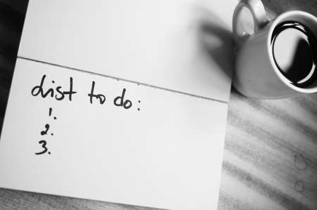 Cup of black coffee and good morning note on the table