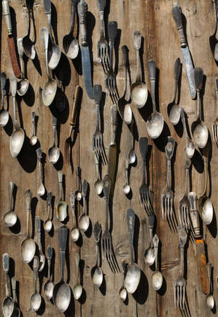 Background of vintage silverware: spoons, teaspoons, knifes, forks and other cutlery on a flea market tableの写真素材