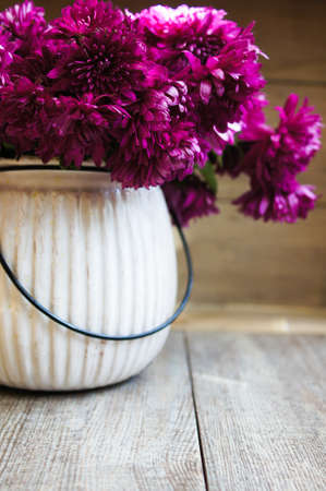 Purple chrysanthemum flowers in a vase on the tableの写真素材