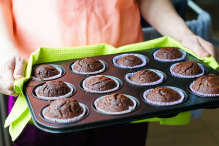 Home made chocolate cupcakes straight from the oven, on a metal tray
