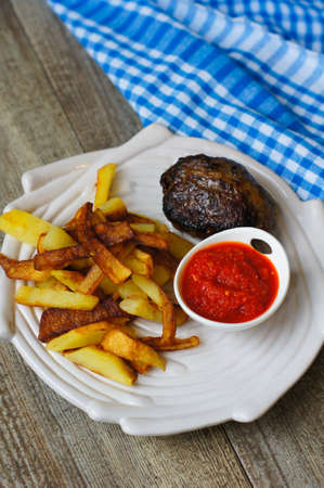 Plate with fried potatoes, vegetables and meat for dinner