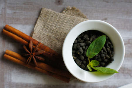 Tea leaves in a cup on the wooden table