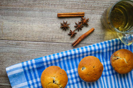 Fresh blueberry and chocolate cupcakes on the wooden table
