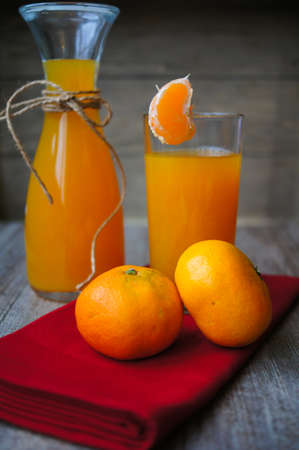Mandarine fresh fruits and juice on the old tableの写真素材