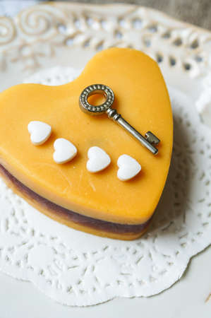 Heart shaped Mocca cake with cup of coffee and Valentine deocrationsの写真素材