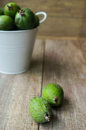Fresh feijoa fruits in a jar on a table