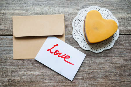 Heart shaped Mocca cake with cup of coffee, coffee beans and Valentine deocrationsの写真素材