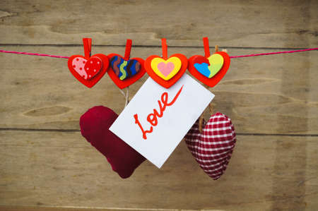 valentine hearts handing on the rope. Valentine's day greeting card. Love concept