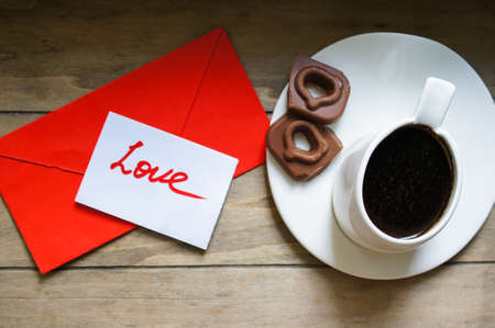 Cup of coffee, hearts and sweets on the chalkboardの写真素材